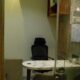 Private cabin workspace with a black ergonomic chair, marble desk, and wall-mounted air conditioner in a coworking office.