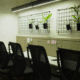 Modern coworking space with ergonomic office chairs, desk plants, and a sleek, well-lit workspace wall at Estancia Coworking in Indore.